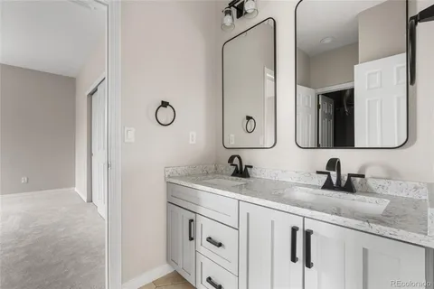 a bathroom with a granite countertop sink vanity and a mirror