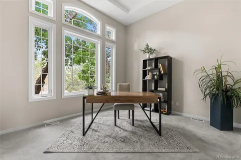 a view of a work space with furniture and window