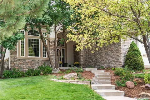 a view of house with a yard