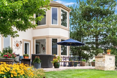 a view of a house with backyard sitting area and garden