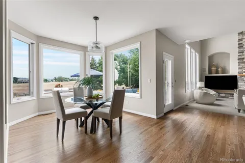 a view of a dining room with furniture window and wooden floor