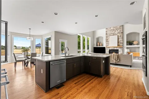 a large kitchen with lots of counter top space and stainless steel appliances