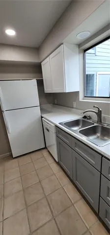 a kitchen with a sink a stove and cabinets