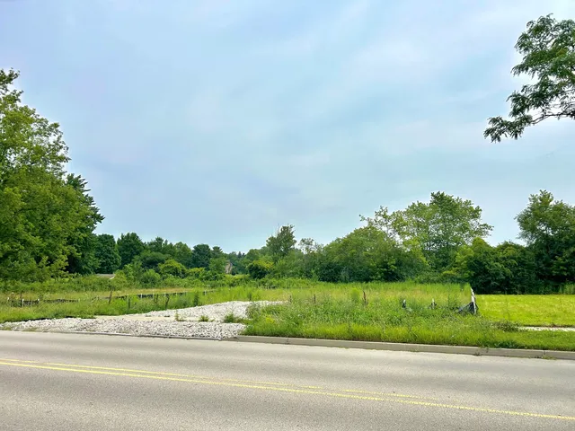 a view of a yard and car parked