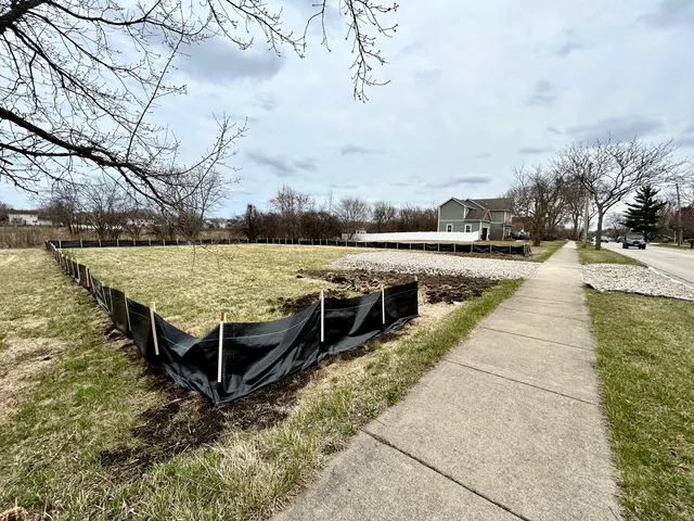 an outdoor space with wooden floor and lake view