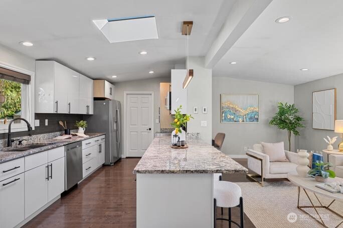 21904 88th Place West Edmonds, WA 98026 - Photo 19 of 40 a kitchen with sink stove and white cabinets with wooden floor