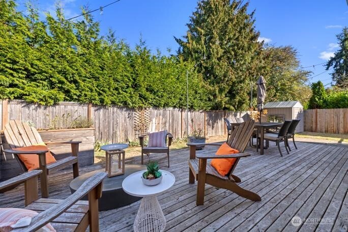 21904 88th Place West Edmonds, WA 98026 - Photo 34 of 40 a backyard of a house with wooden floor table and chairs