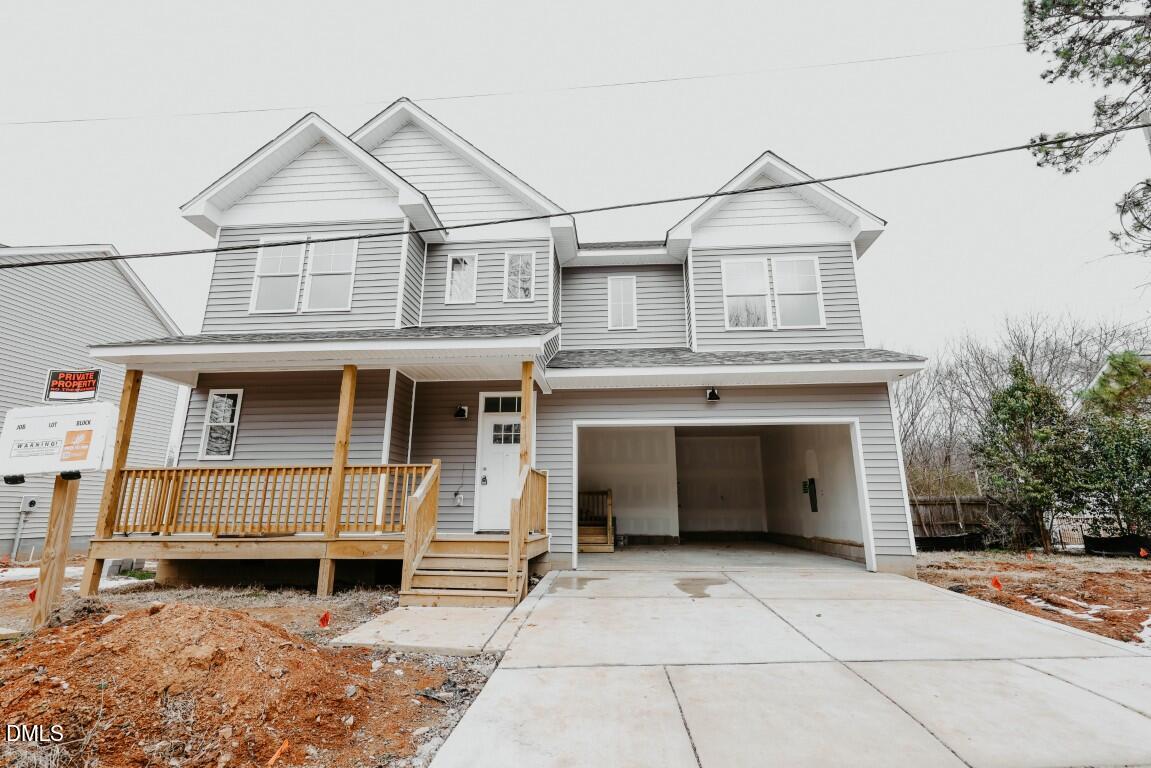 a view of a house with a yard and garage