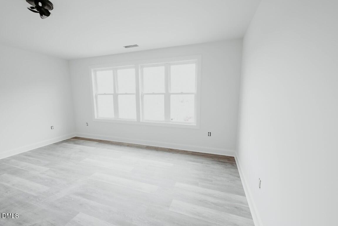 309 East Perry Avenue Wake Forest, NC 27587 - Photo 11 of 24 a view of an empty room with a window