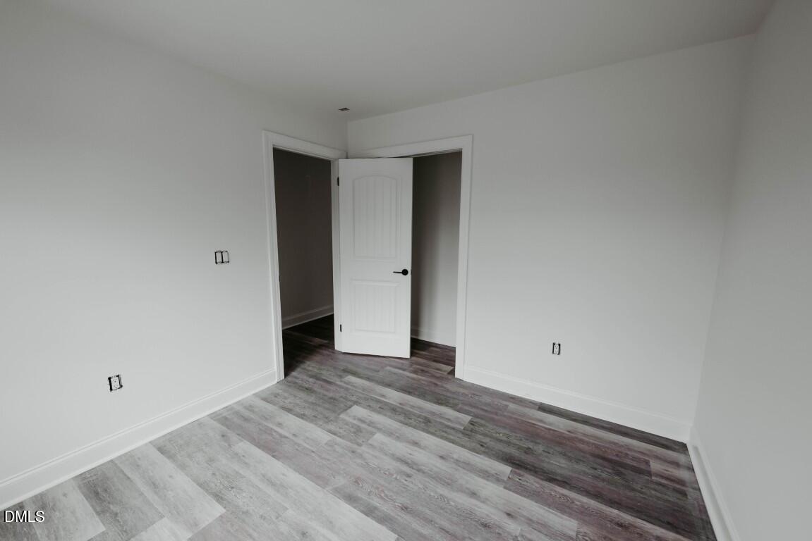 309 East Perry Avenue Wake Forest, NC 27587 - Photo 15 of 24 a view of an empty room with wooden floor