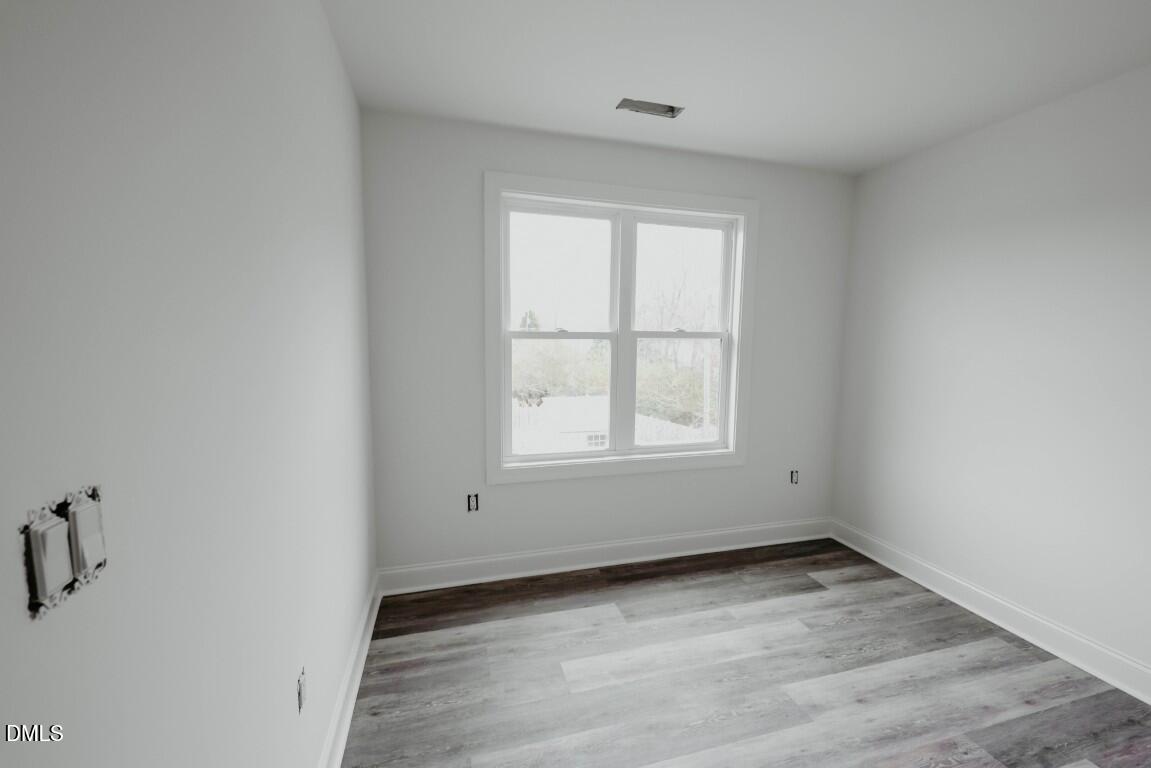 309 East Perry Avenue Wake Forest, NC 27587 - Photo 19 of 24 an empty room with a window