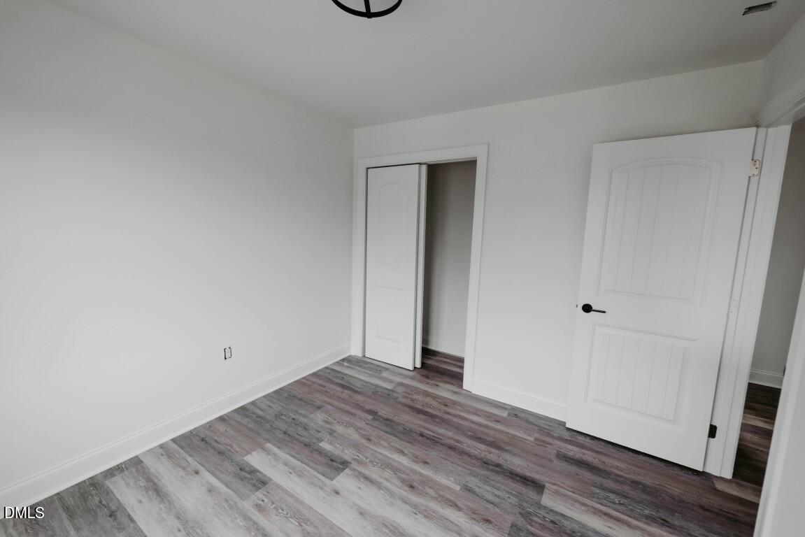 309 East Perry Avenue Wake Forest, NC 27587 - Photo 20 of 24 a view of room with wooden floor
