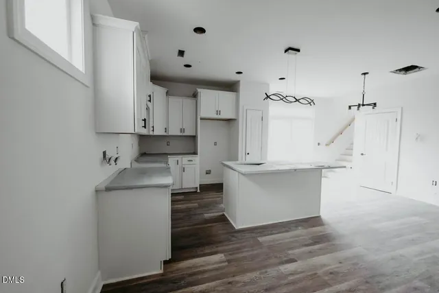 a view of kitchen with wooden floor and electronic appliances