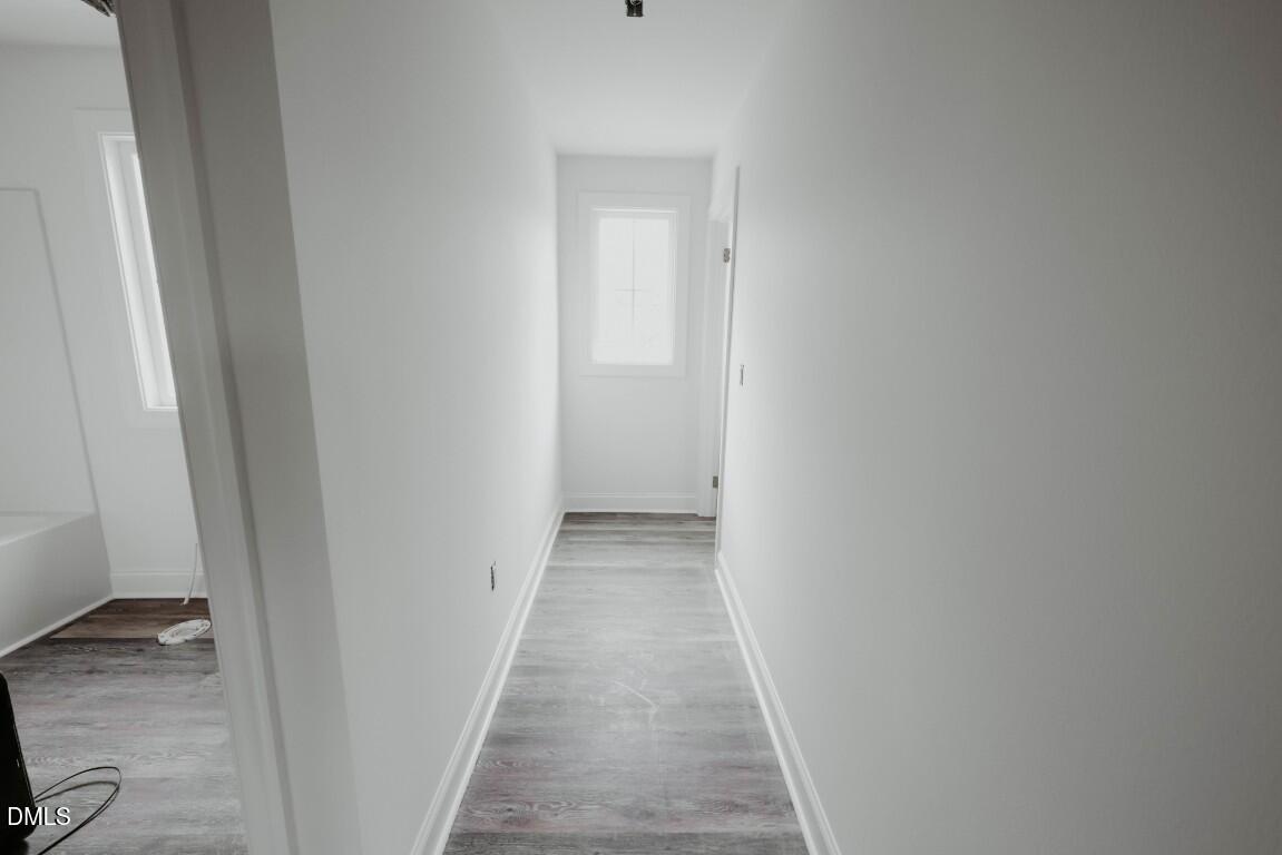 309 East Perry Avenue Wake Forest, NC 27587 - Photo 22 of 24 a view of a hallway with wooden floor