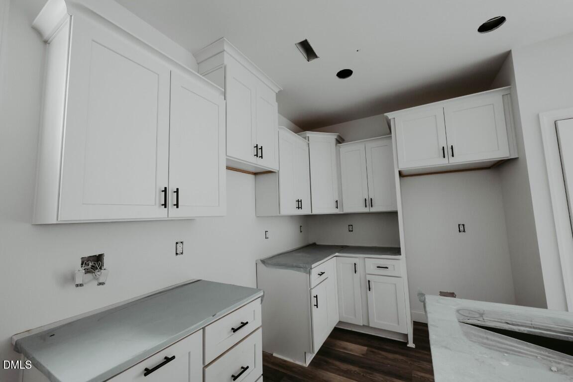 309 East Perry Avenue Wake Forest, NC 27587 - Photo 3 of 24 a view of cabinets with wooden floor