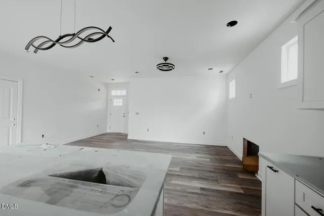 a view of a room with wooden floor and utility room