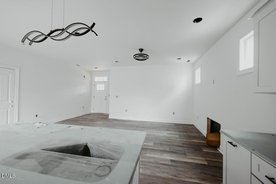 309 East Perry Avenue Wake Forest, NC 27587 - Photo 4 of 24 a view of a room with wooden floor and utility room