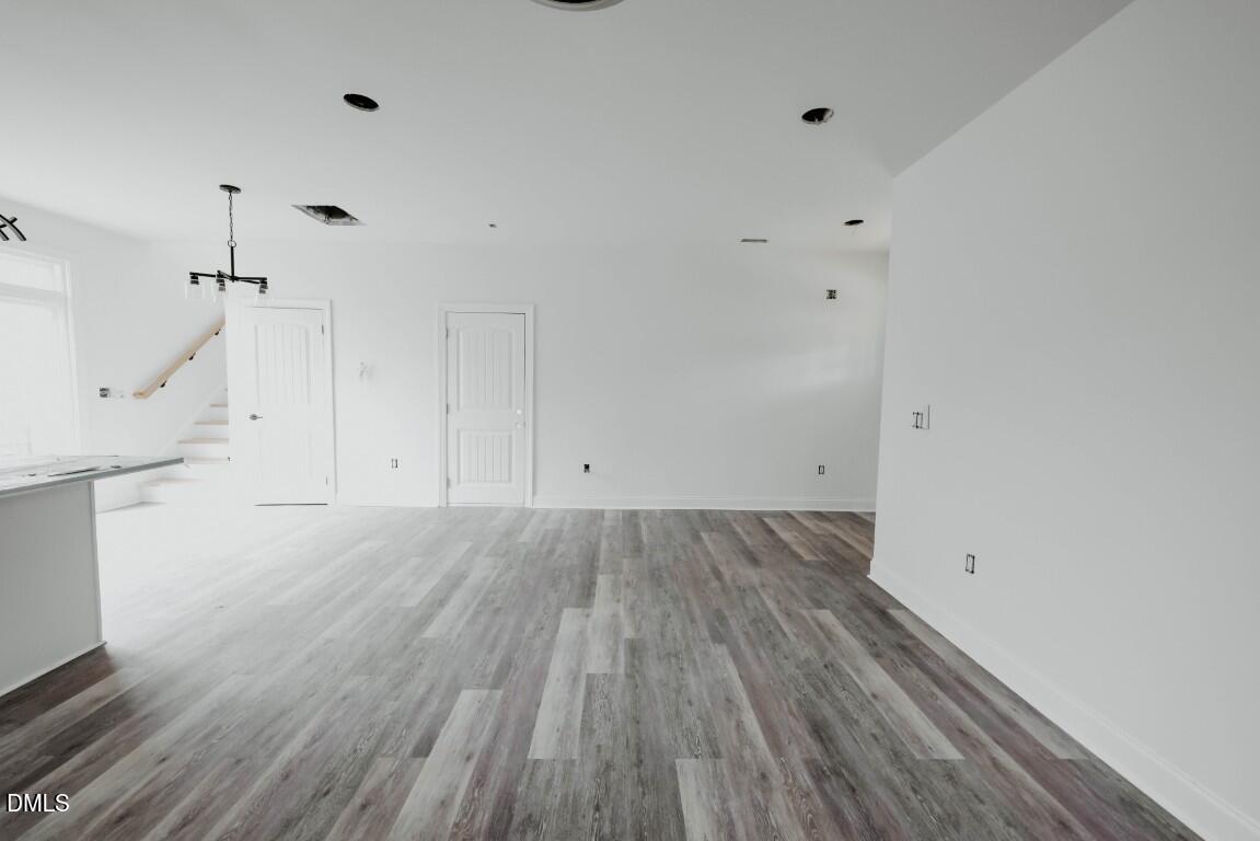 309 East Perry Avenue Wake Forest, NC 27587 - Photo 5 of 24 a view of an empty room with wooden floor