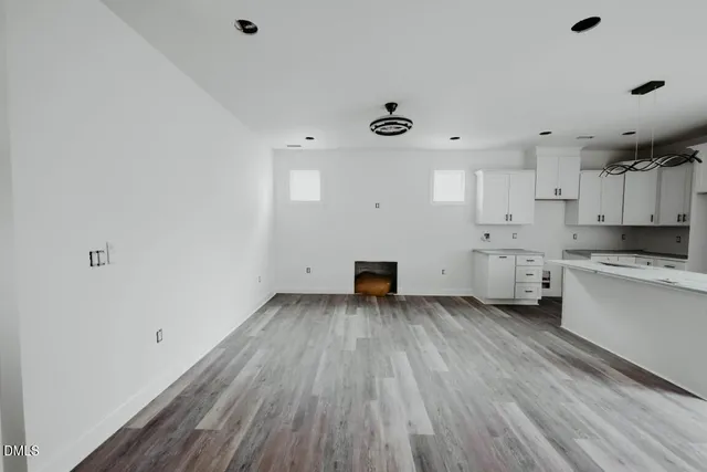 a view of a kitchen with wooden floor