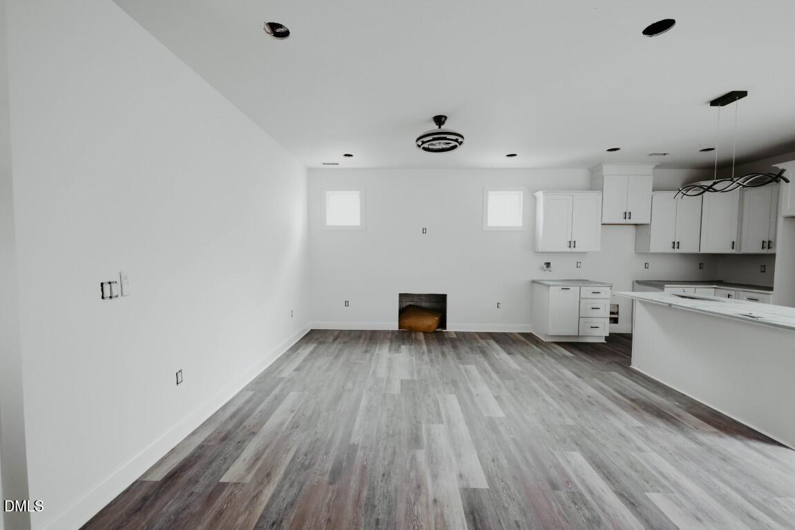 309 East Perry Avenue Wake Forest, NC 27587 - Photo 6 of 24 a view of a kitchen with wooden floor