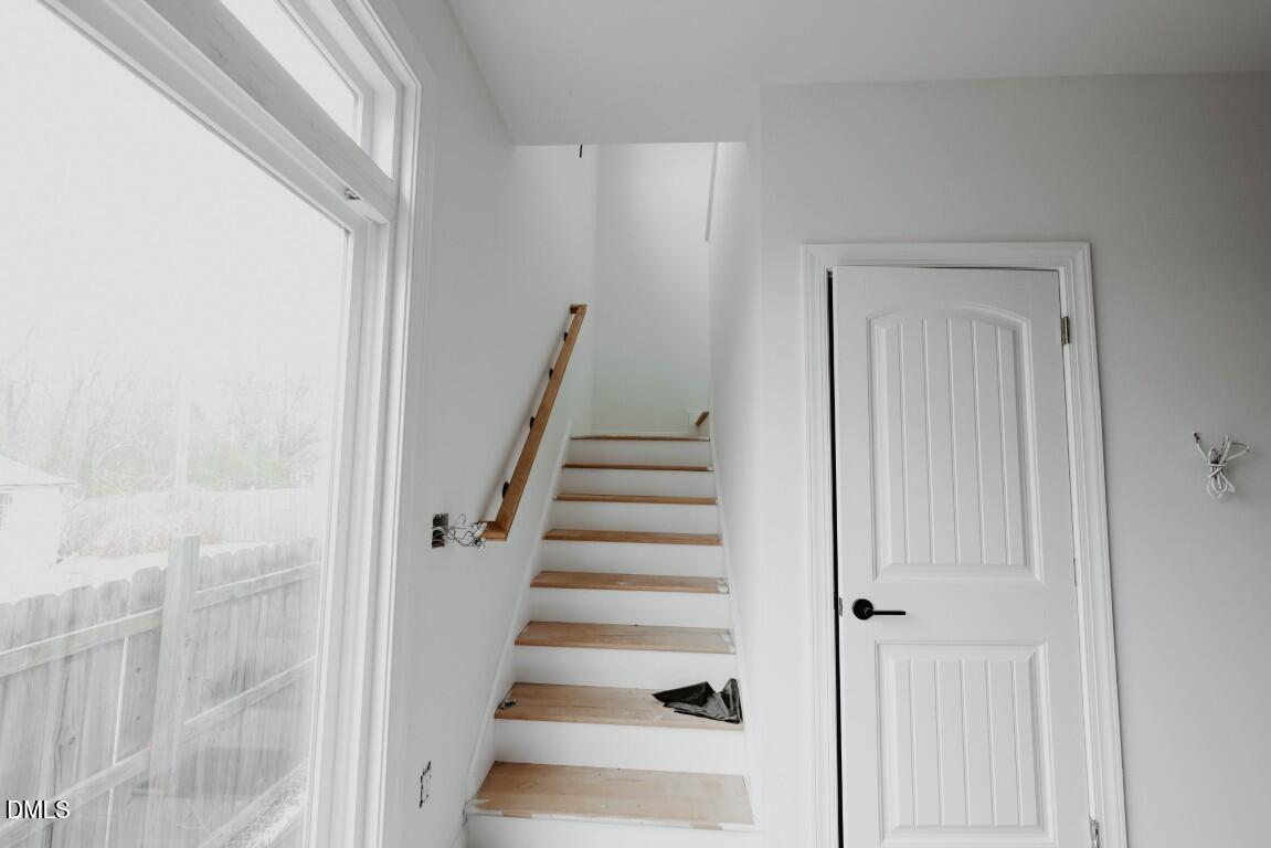 309 East Perry Avenue Wake Forest, NC 27587 - Photo 9 of 24 a view of staircase with white walls and white door