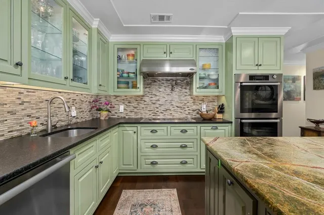 a kitchen with granite countertop a sink and cabinets