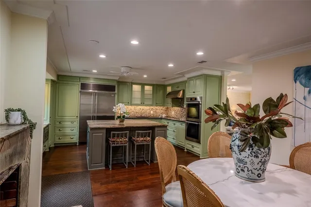 a kitchen with granite countertop a stove cabinets and wooden floor