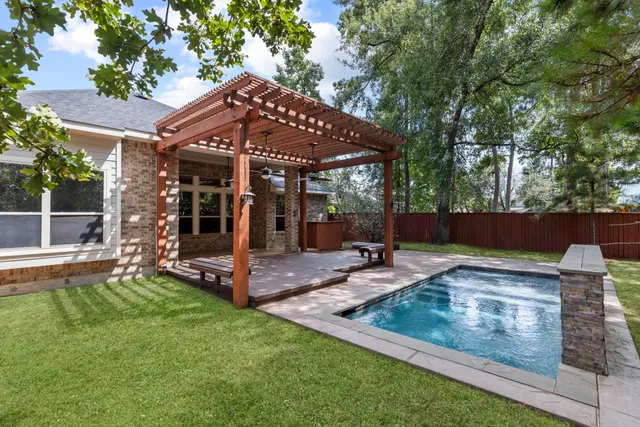 a view of a house with backyard and sitting area