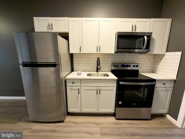 a kitchen with a refrigerator sink and microwave