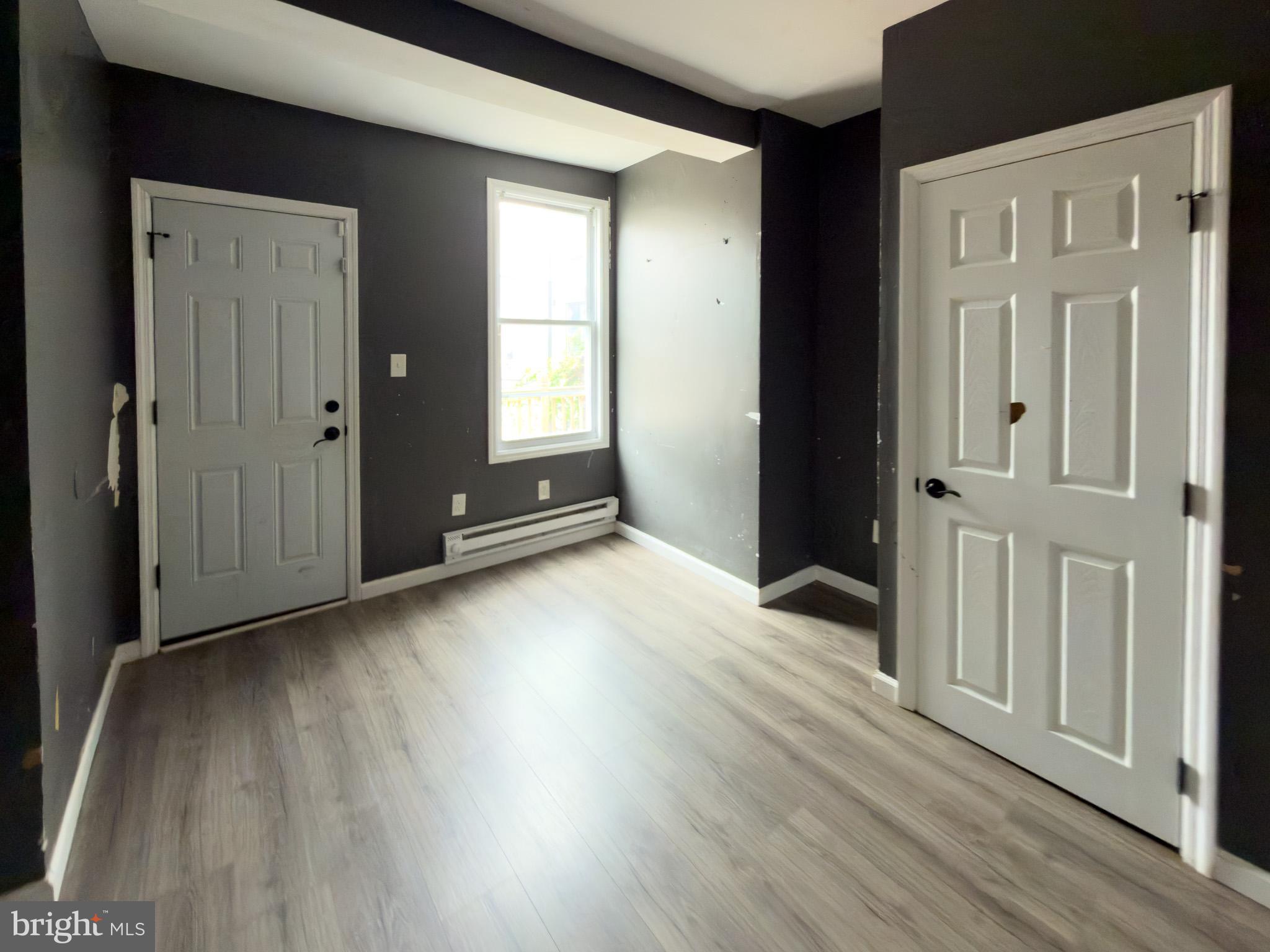 826 Union Street Philadelphia, PA 19104 - Photo 7 of 16 an empty room with wooden floor and windows