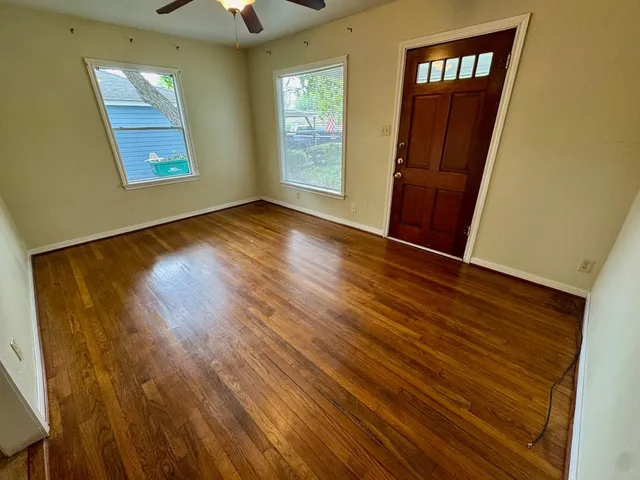 wooden floor in an empty room with a window