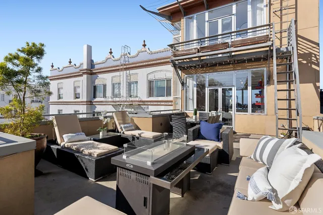 a view of a patio with couches table and chairs and potted plants