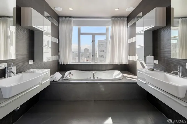 a bathroom with a tub a sink and a bathtub