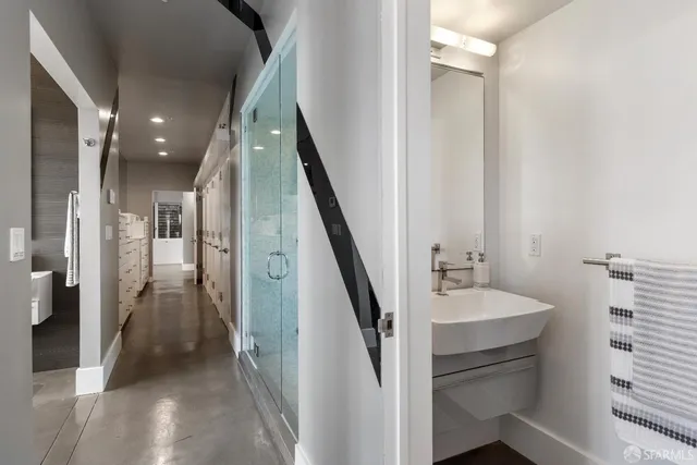 a view of a hallway with furniture and stairs