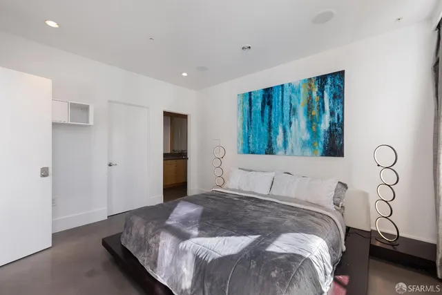 a bedroom with a large bed and a window