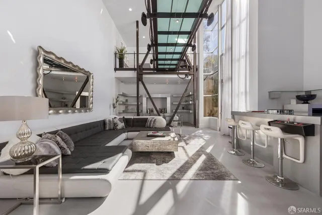 a living room with furniture a flat screen tv and a large window