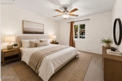 a bedroom with bed and a chandelier
