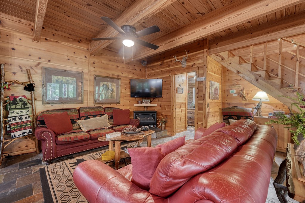 4836 Swallows Creek Road Hiawassee, GA 30546 - Photo 17 of 57 a living room with furniture a fireplace and a flat screen tv