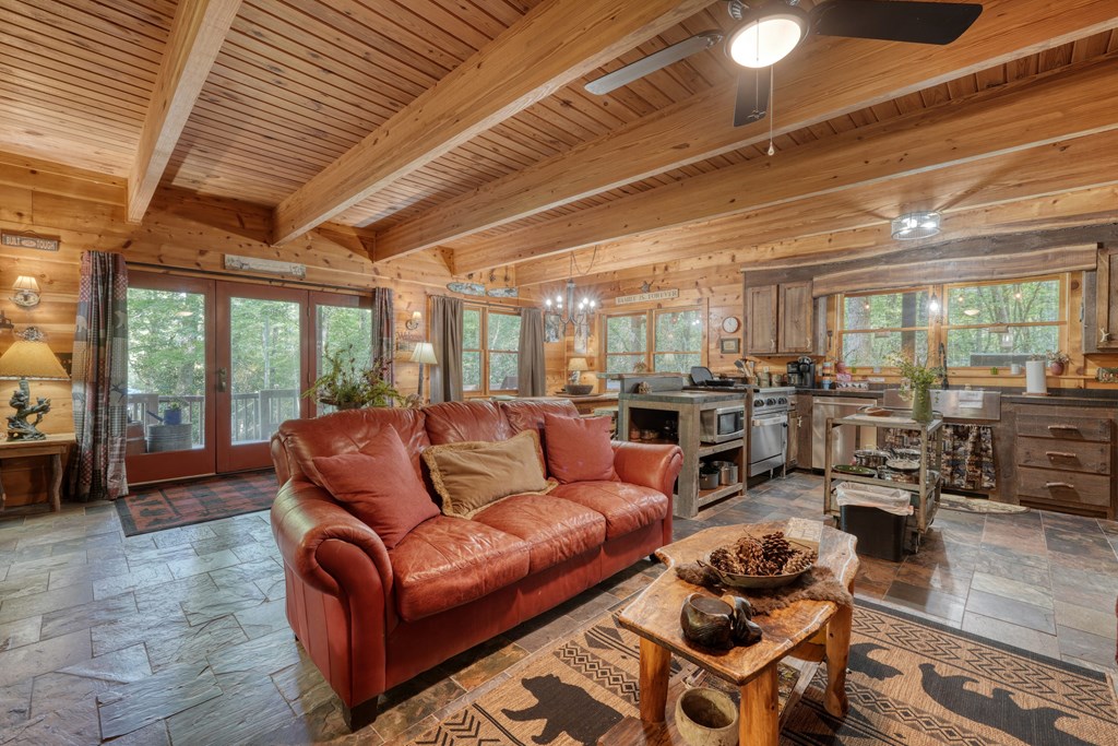 4836 Swallows Creek Road Hiawassee, GA 30546 - Photo 18 of 57 a living room with furniture kitchen view and a large window