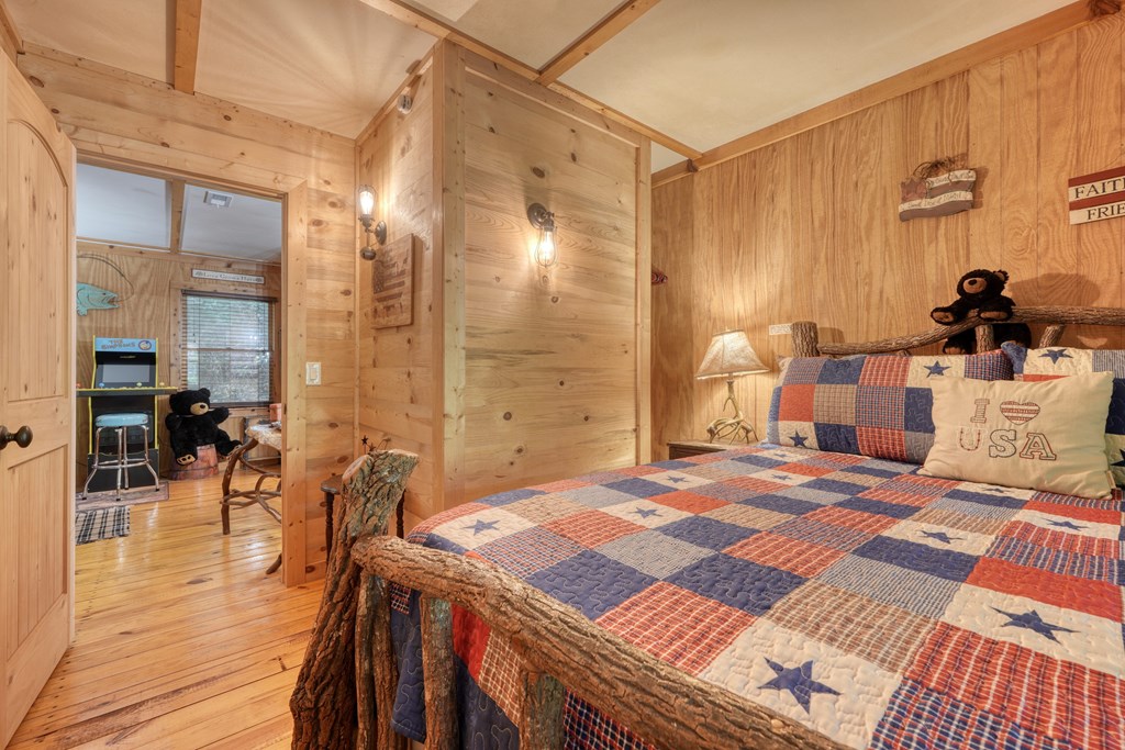 4836 Swallows Creek Road Hiawassee, GA 30546 - Photo 29 of 57 a bedroom with a bed and a table