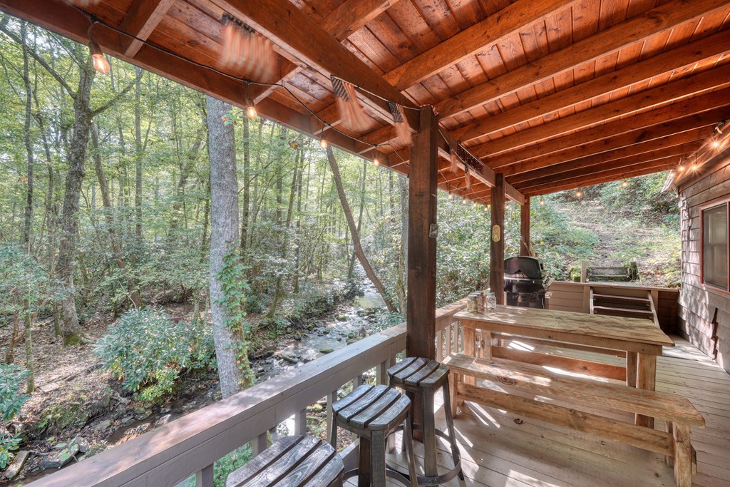 4836 Swallows Creek Road Hiawassee, GA 30546 - Photo 37 of 57 a view of a patio with table and chairs and wooden floor
