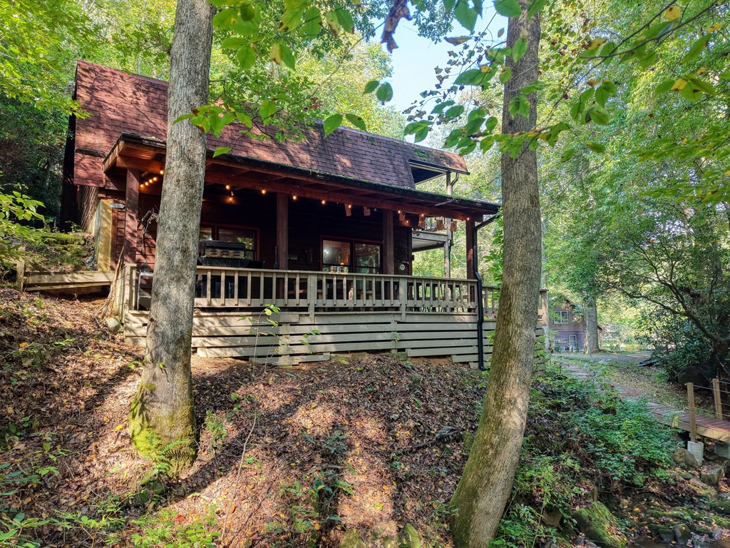 4836 Swallows Creek Road Hiawassee, GA 30546 - Photo 5 of 57 a view of a house with a small yard and large tree