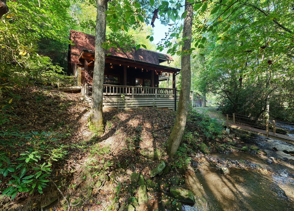 4836 Swallows Creek Road Hiawassee, GA 30546 - Photo 6 of 57 a view of a house with a tree in the yard
