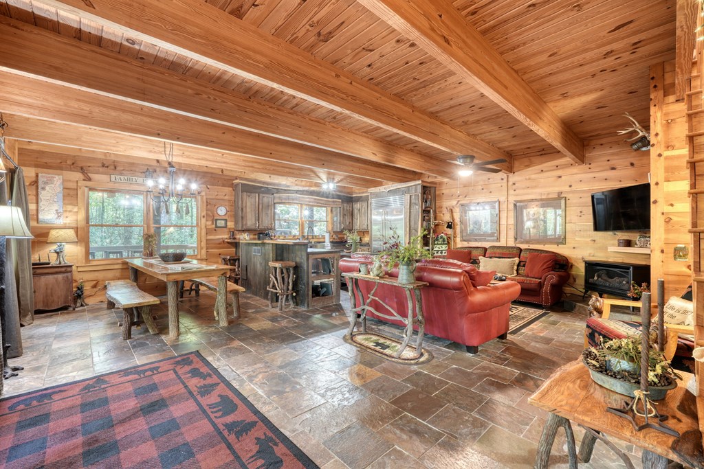 4836 Swallows Creek Road Hiawassee, GA 30546 - Photo 9 of 57 a room with lots of furniture and a flat screen tv