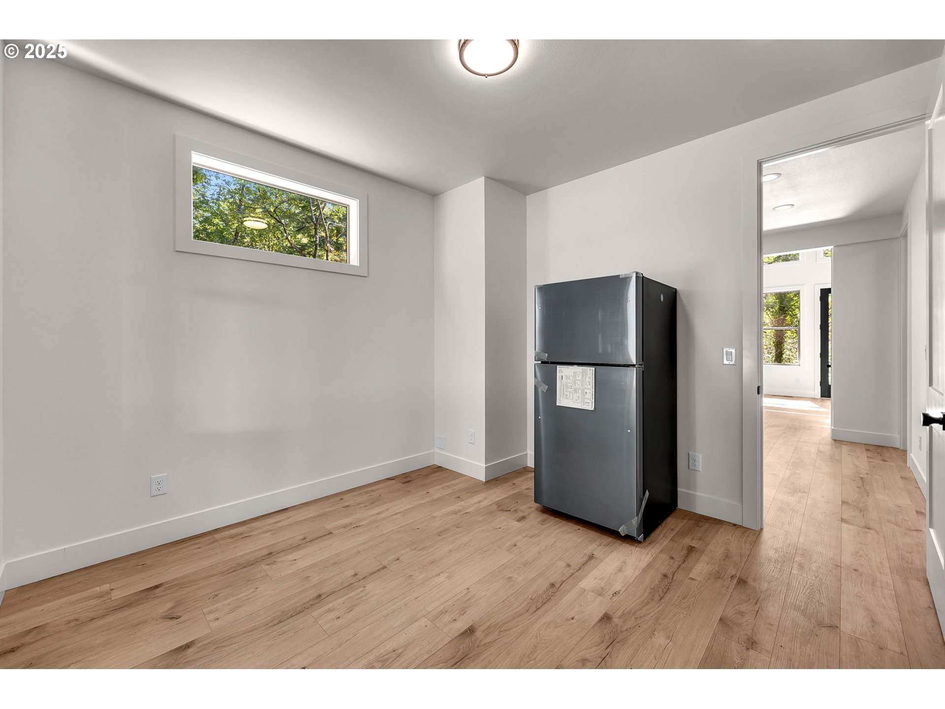 36403 Northeast 267th Street Yacolt, WA 98675 - Photo 14 of 33 a view of an empty room with wooden floor and a window
