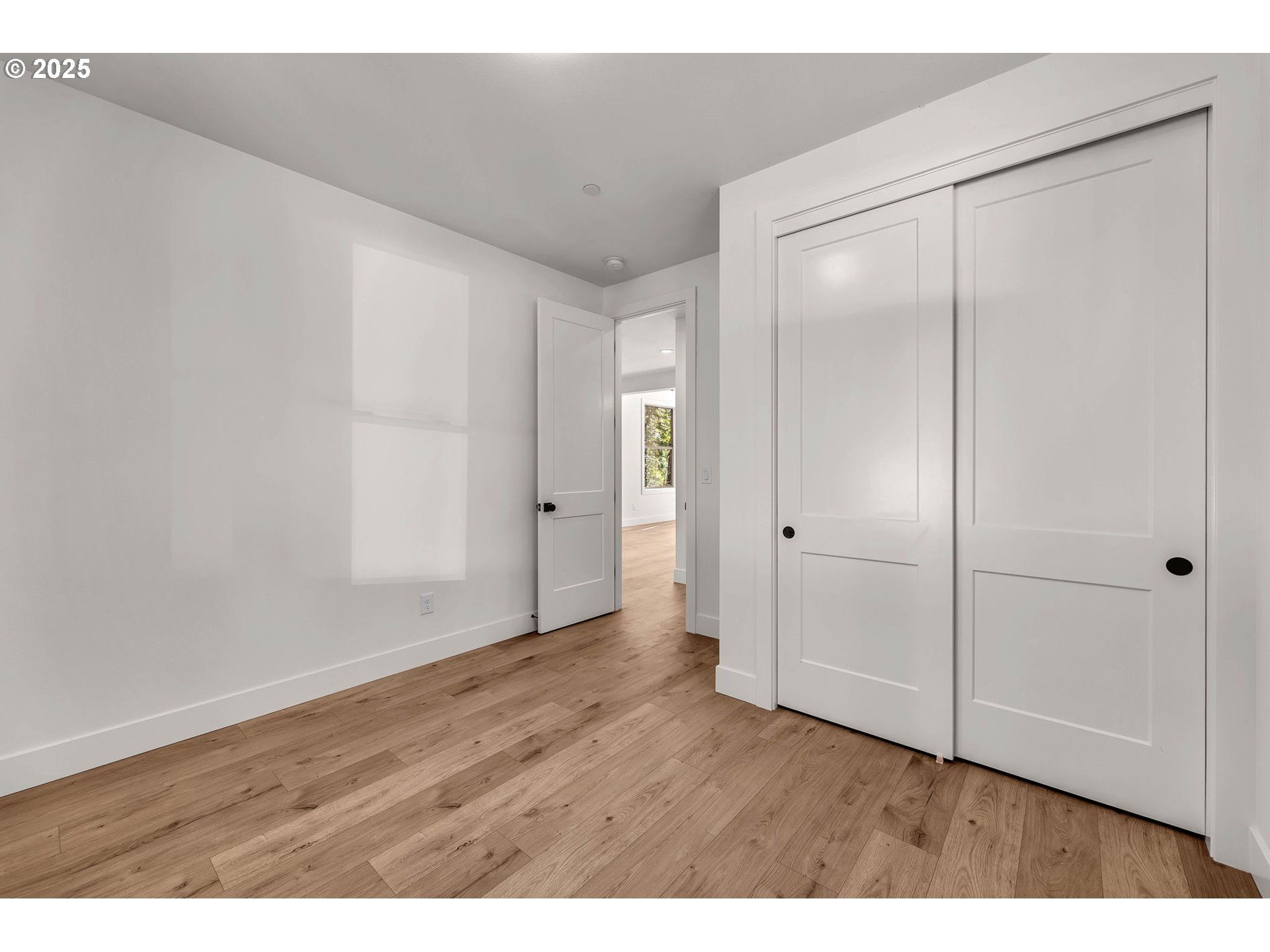 36403 Northeast 267th Street Yacolt, WA 98675 - Photo 16 of 33 a view of an empty room with wooden floor and closet area