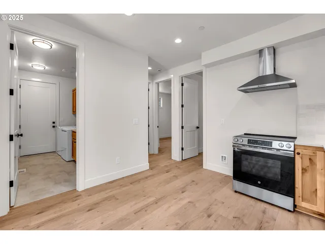 a view of a kitchen with a stove cabinets and a wooden floor