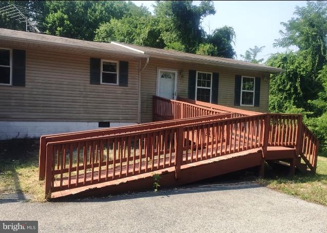 96 Sheckells Road Huntingtown, MD 20639 - Photo 14 of 17 a view of a wooden deck with a bench
