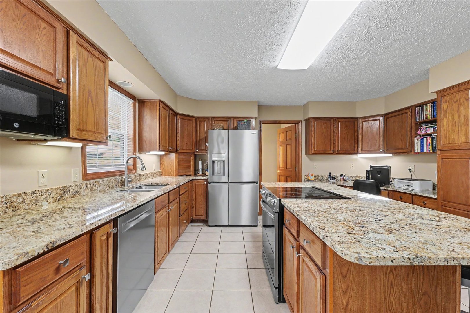 4409 Copper Ridge Road Champaign, IL 61822 - Photo 14 of 40 a kitchen with a sink stove and refrigerator