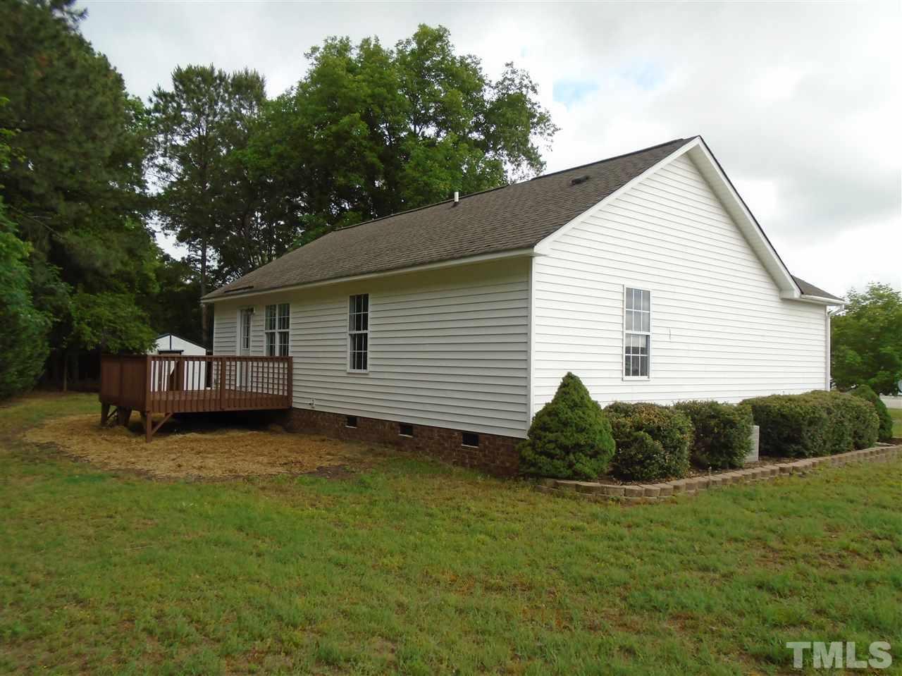 289 Wagner Road Willow Spring, NC 27592 - Photo 2 of 12 a backyard of a house with table and chairs